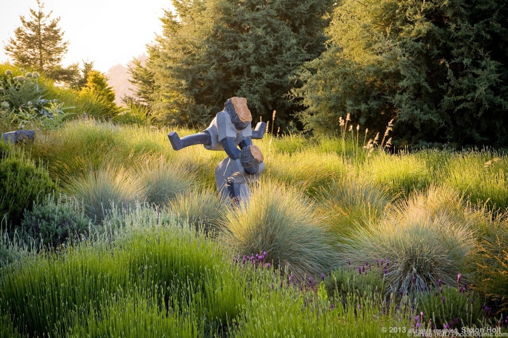 Art, sculpture of children playing leapfrog in California meadow garden
